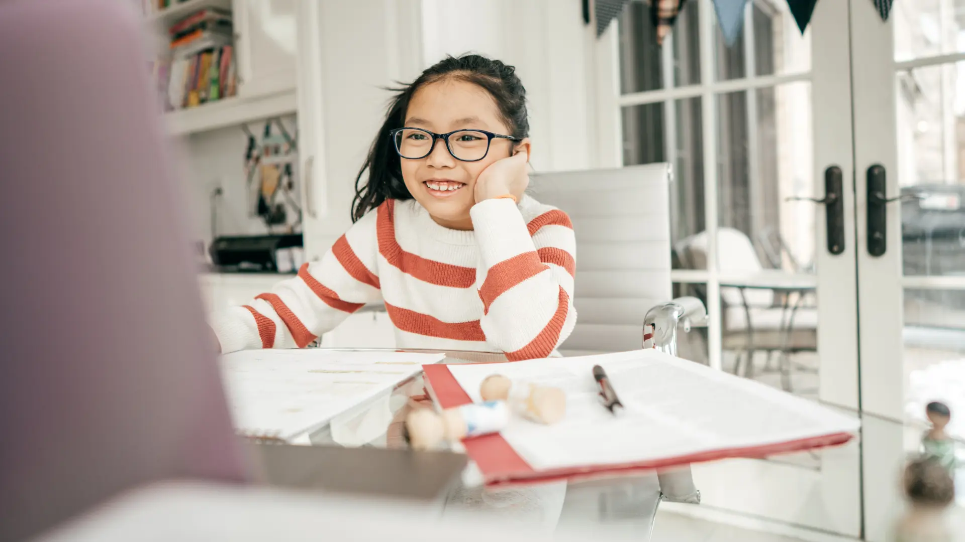 A student smiling while learning English online at home